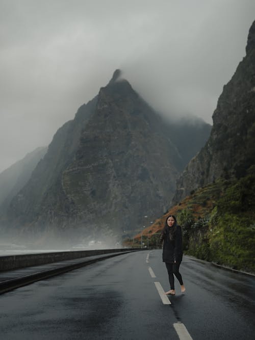 Woman on Road in Majestic Mountains