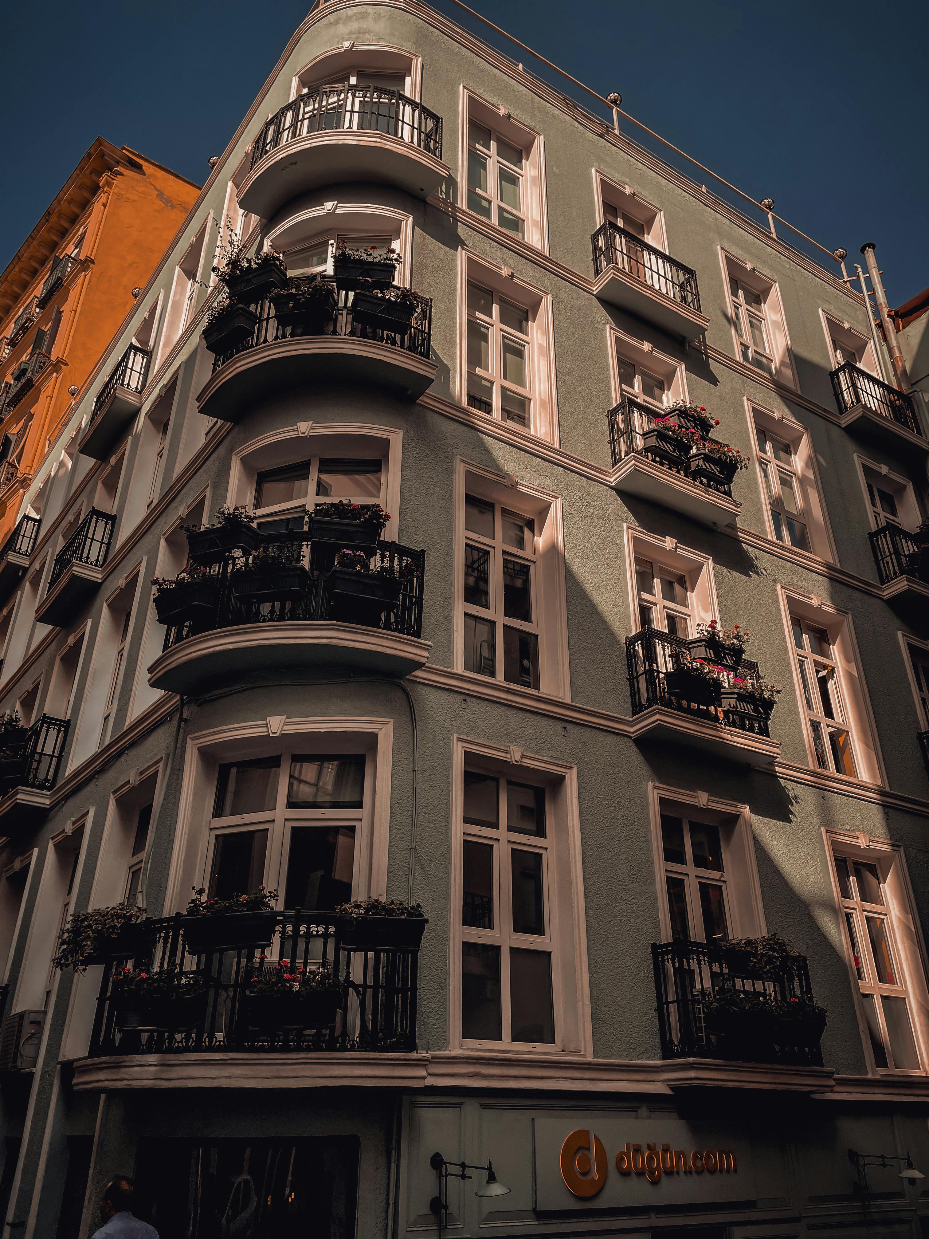 Free Close-up view of a stylish urban apartment facade with balconies, showcasing architectural beauty. Stock Photo