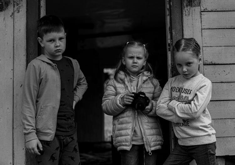 Kids With Camera Standing In Doorway