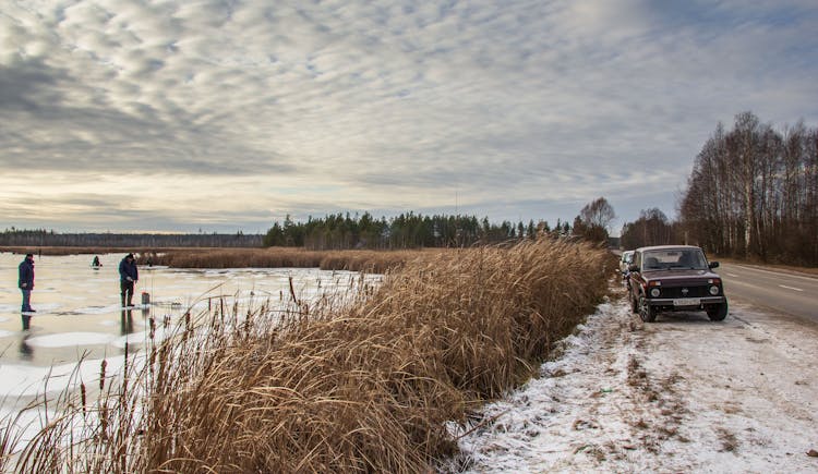 People Fishing In Winter Lake