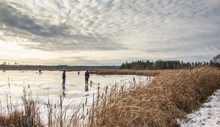 Fishermen On Frozen Lake