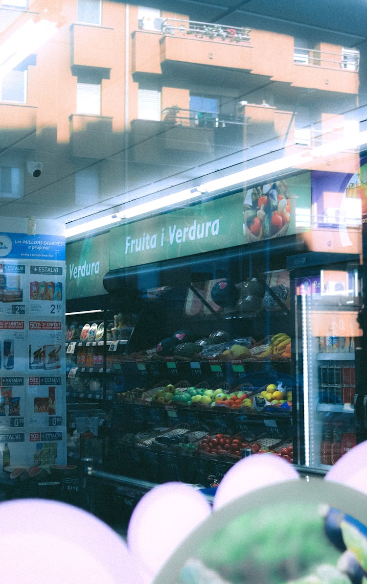 A Grocery Aisle Seen Through A Window