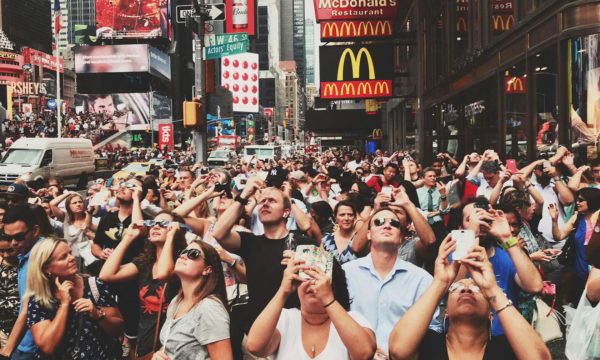 Crowd of People in a City Looking at up and Taking Photographs