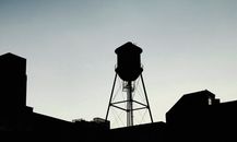 Silhouette of Old Mine Structure Against Sky