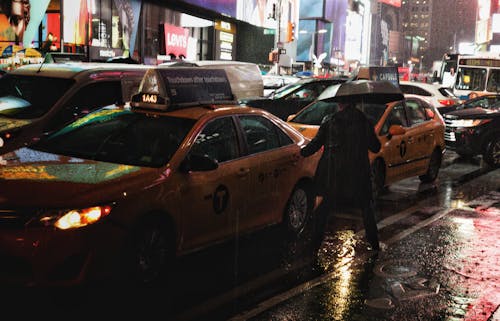 Motor Vehicles on the Road During Rainy Day