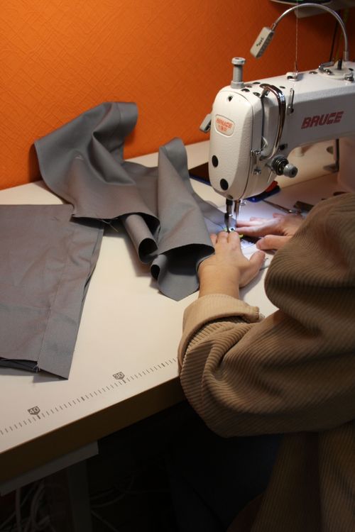 A Person Using a Sewing Machine · Free Stock Photo