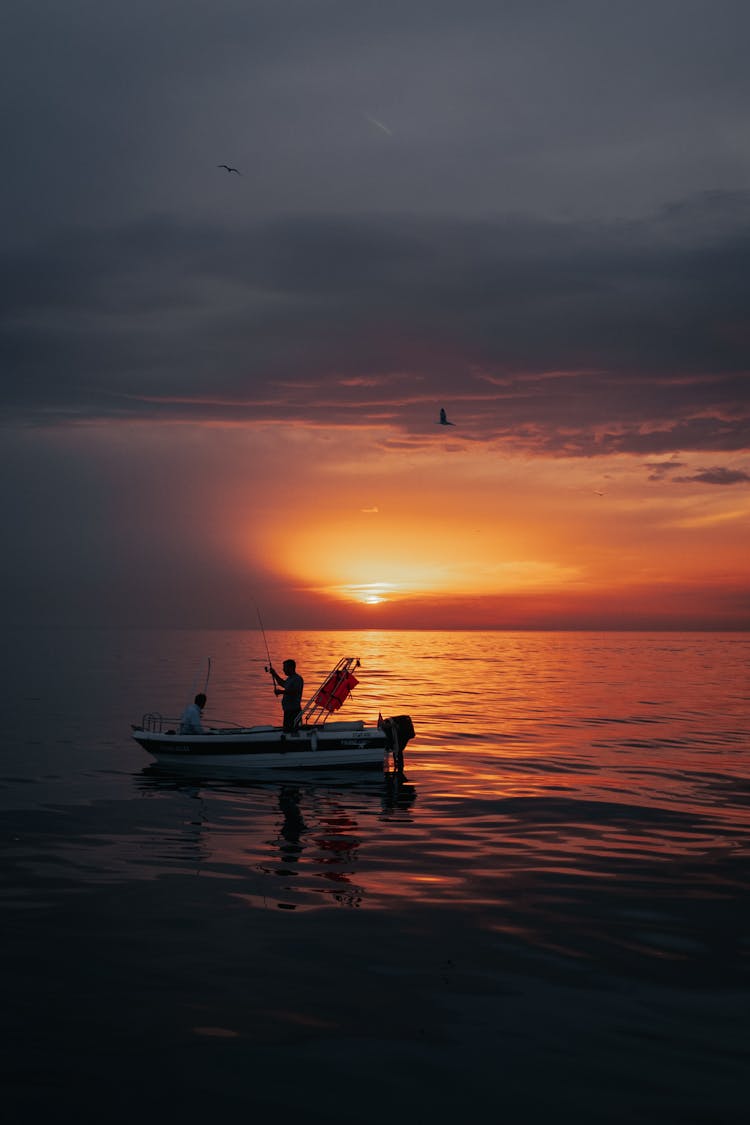 Sunset Over Fishermen On Boat