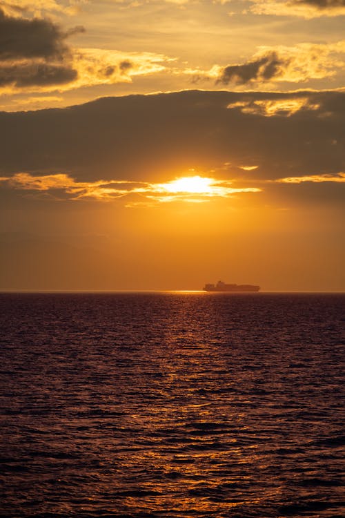 Silhouette of a Ship at Sea during Sunset