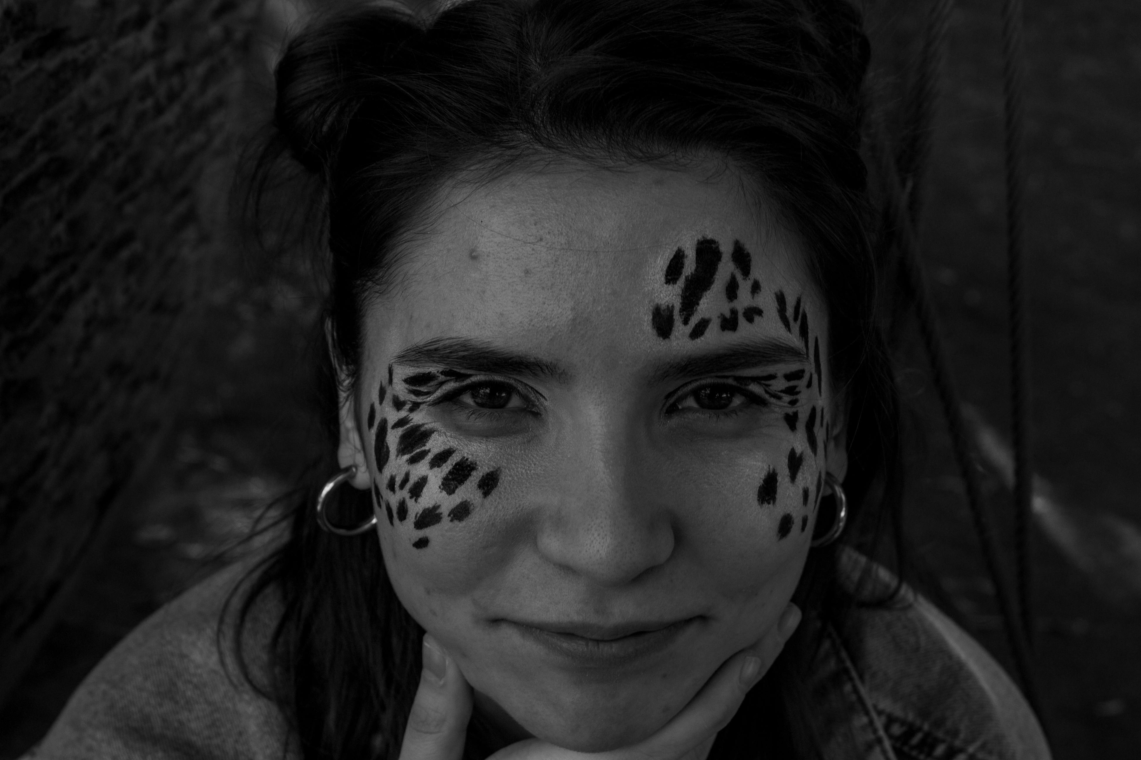 Grayscale Photo of a Woman with Face Paint · Free Stock Photo