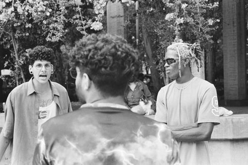 Free Group of young men having an animated discussion outdoors in black and white. Stock Photo