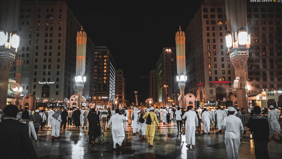 Women respectfully wearing abayas in a public space in Saudi Arabia