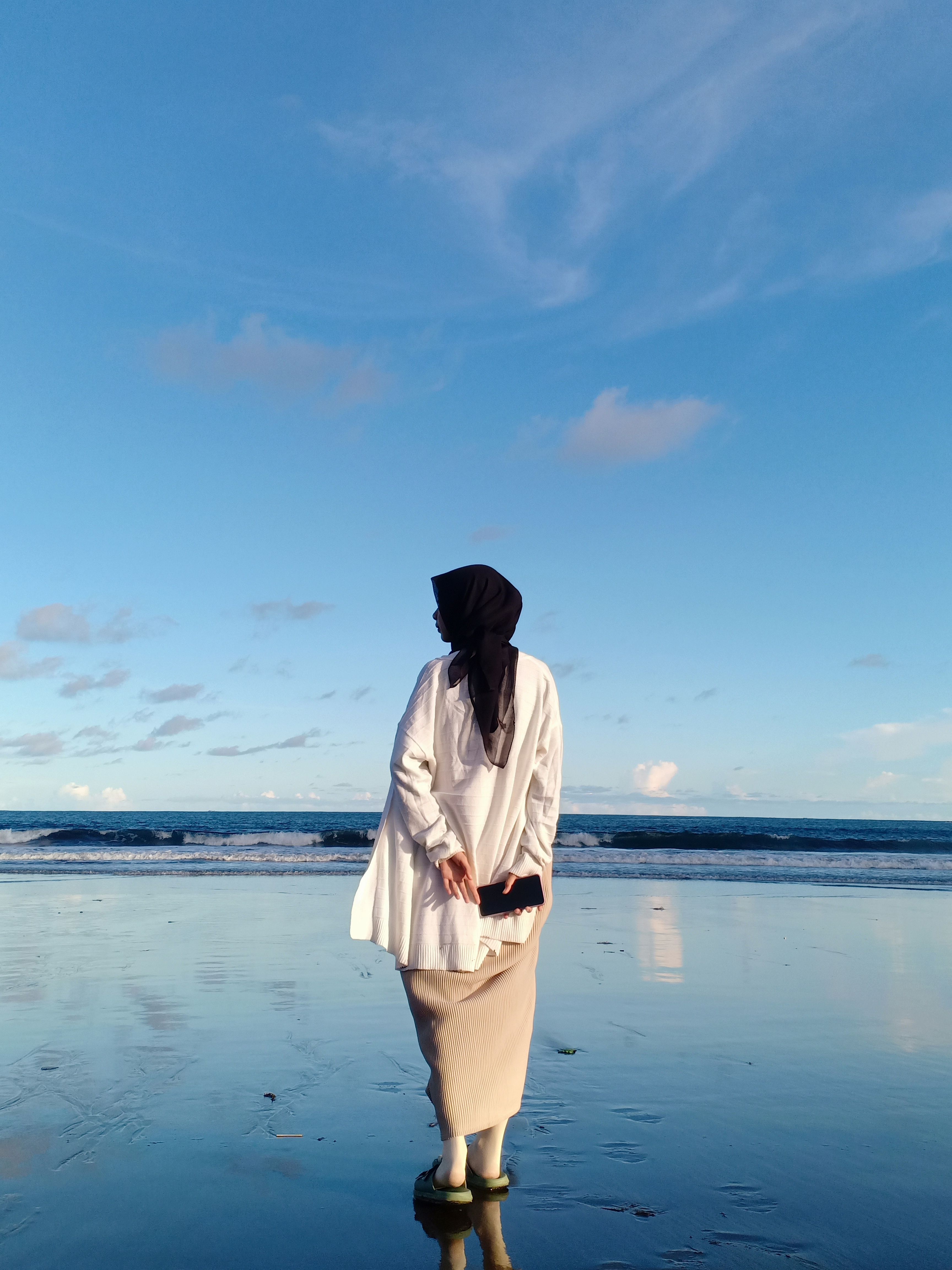 Woman in Black Hijab Walking on the Shore · Free Stock Photo
