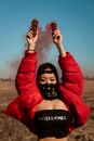Woman in Black Brassiere and Red Jacket With Black Mask