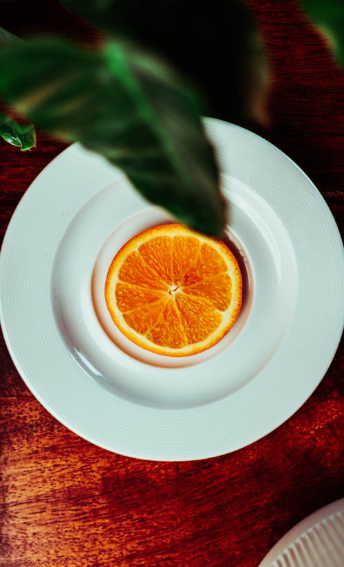 Slice of Orange Fruit on White Ceramic Bowl