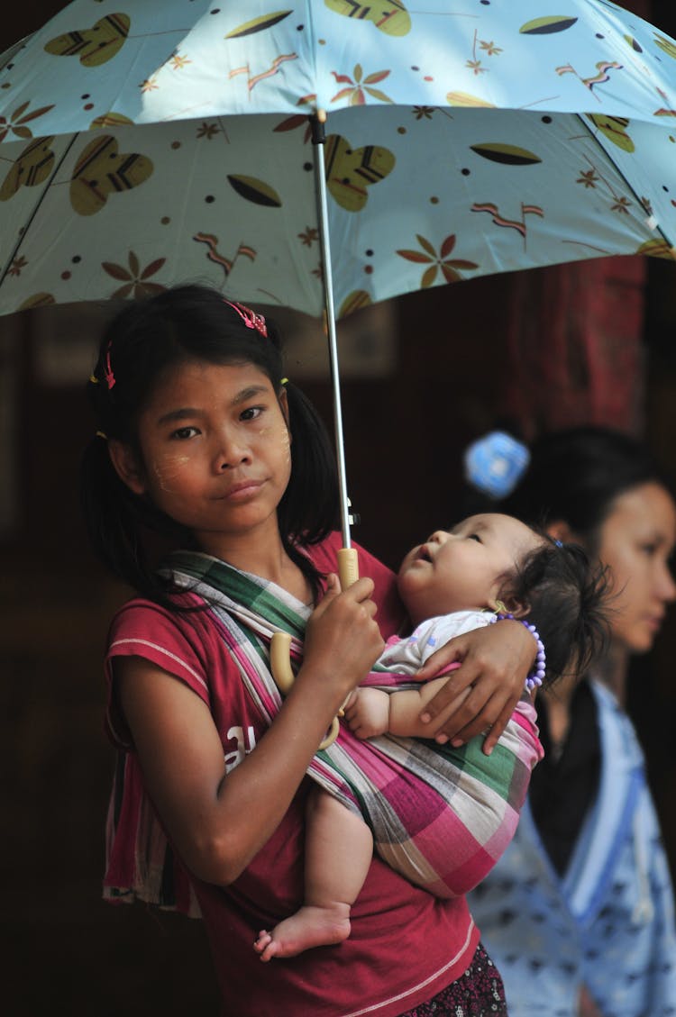 Girl Carrying A Baby 