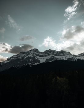 Snow-capped Canadian Rockies under dramatic clouds, Alberta landscape