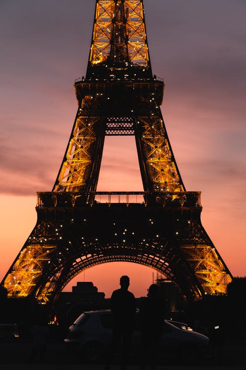 Silhouetted and Illuminated Eiffel Tower Against Pink Sky · Free Stock ...