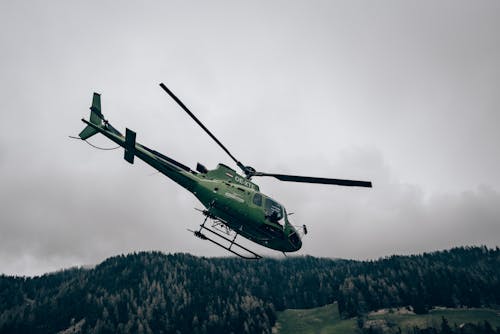 Green Helicopter Flying over Green Trees