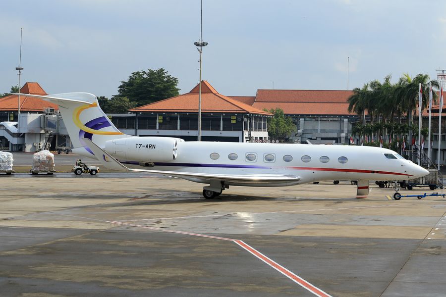 Private jet parked on an airport runway for destination wedding travel logistics
