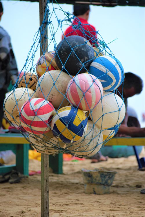 Free Net bag with colorful volleyballs on a sandy beach in East Kalimantan, Indonesia. Stock Photo