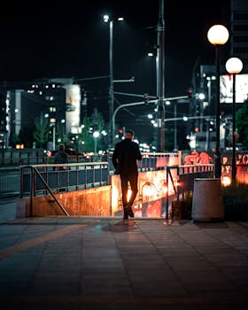 A man enters a Warsaw subway at night, highlighting urban life in Poland.