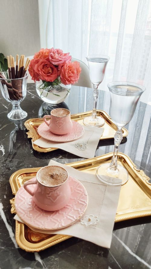 Free Beautiful coffee setup with pink ceramic cups and roses on a marble table. Stock Photo