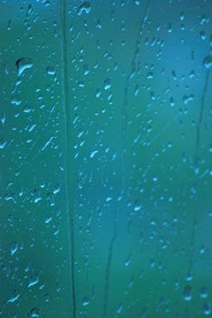 Close-up of rain droplets on a glass window in Balikpapan, showcasing nature's beauty.