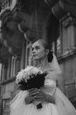Woman in White Dress Holding Bouquet of Flowers