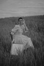 Woman in White Dress Sitting on Grass Field