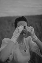 Grayscale Photo of Woman in Dress Shirt Covering Her Face With Her Hands