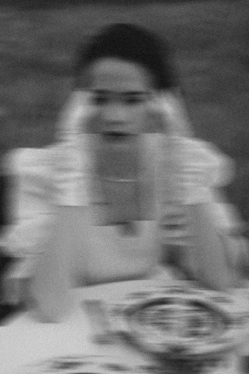 Free Blurred black and white image of a woman sitting with a dreamy, artistic effect. Stock Photo