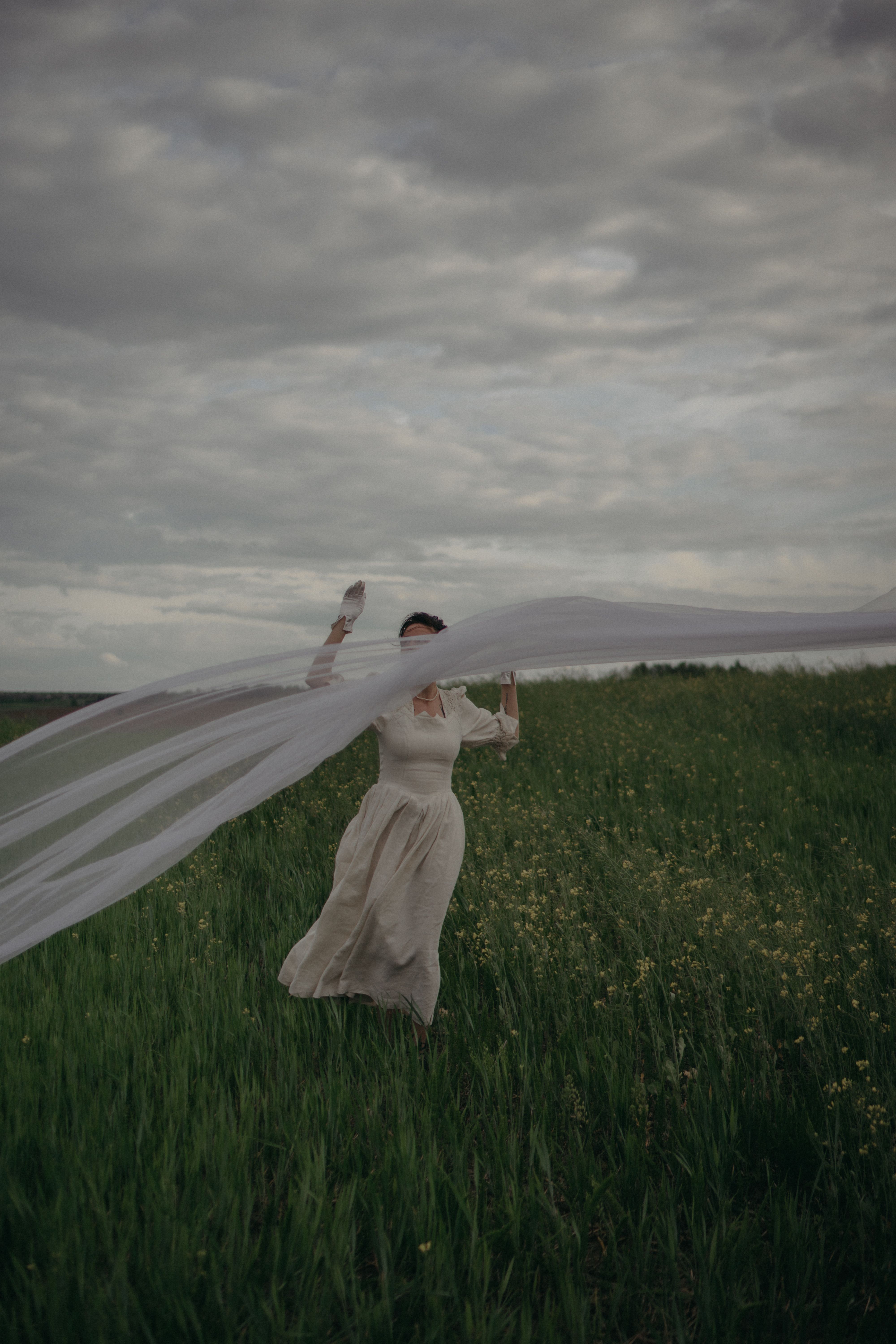 A Woman in White Dress Standing on Green Grass Field · Free Stock Photo
