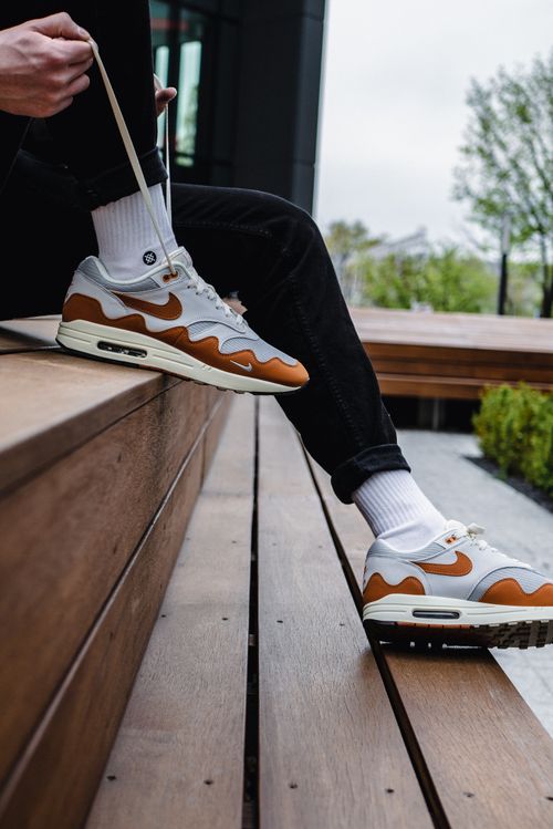 Free Close-up of stylish Nike Air sneakers being worn outdoors, with a focus on design and fashion. Stock Photo