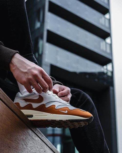Free Close-up of stylish Nike sneakers worn in an urban setting, showcasing modern streetwear fashion. Stock Photo