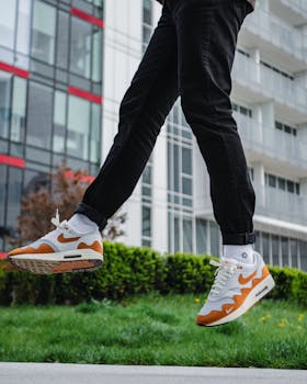 Stylish jump showcasing Nike sneakers in urban setting, perfect for sportswear fashion