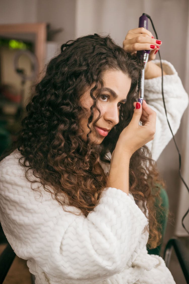 Woman Straightening Hair