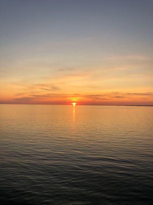 Free Beautiful sunset over the calm ocean in Stockholm, capturing the golden hour hues. Stock Photo