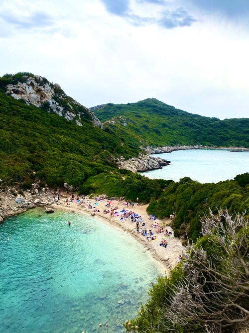 Free Breathtaking aerial view of Porto Timoni Beach in Corfu, Greece, showcasing lush greenery and turquoise waters. Stock Photo