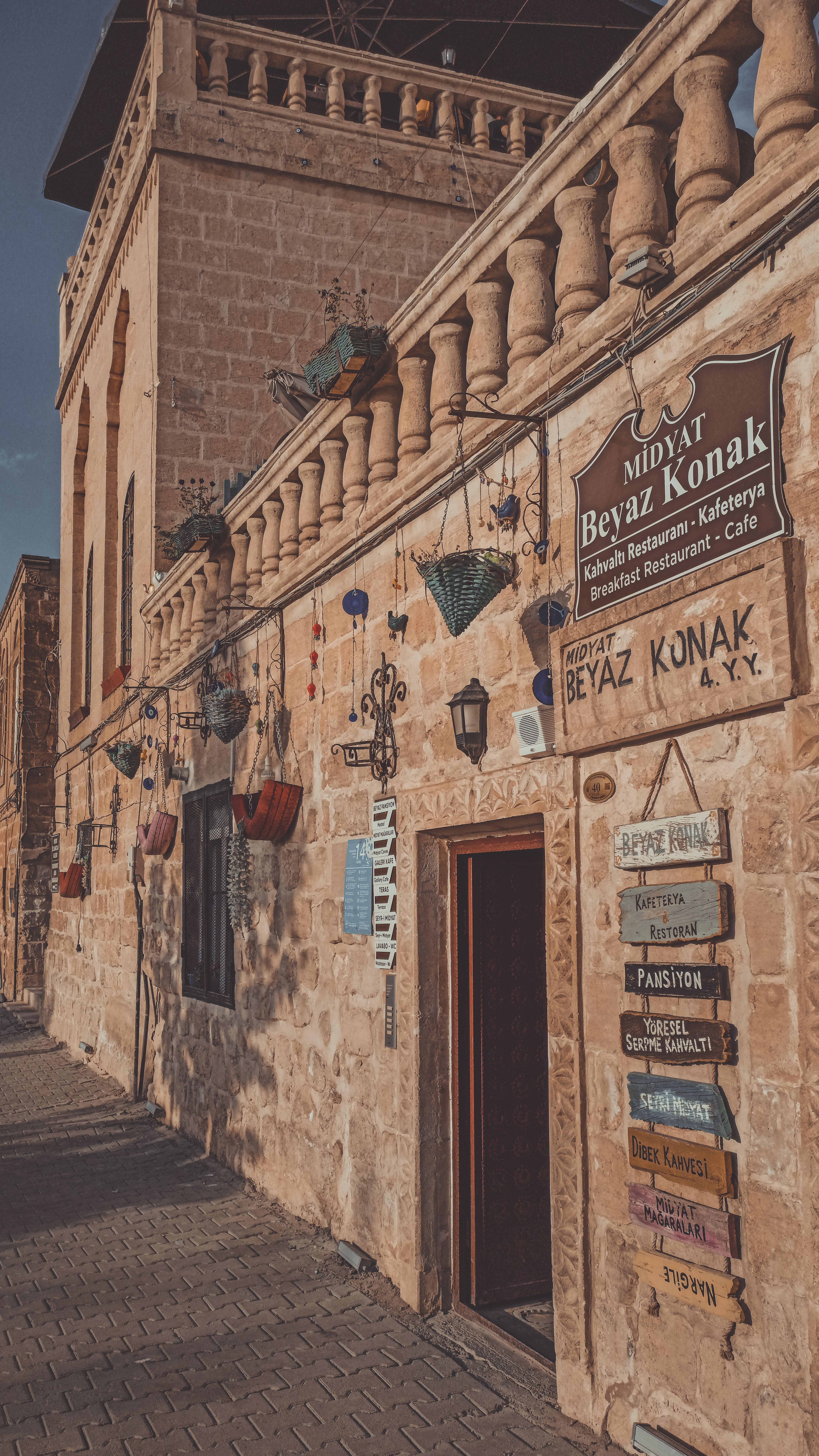 Explore the rustic facade of a Midyat cafe with traditional Middle Eastern charm.