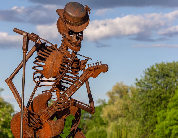 A Rusty Skeleton Playing A Guitar