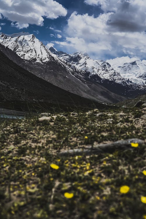 Snow Covered Mountains Under Cloudy Sky