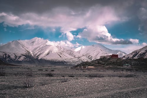 A Snow Covered Mountain Under the Cloudy Sky