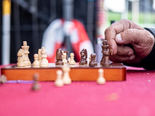 A Close-up Shot of a Person Playing Chess