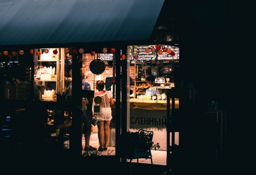 Free A vibrant night scene of a couple shopping inside a brightly lit store in Sochi, Russia. Stock Photo