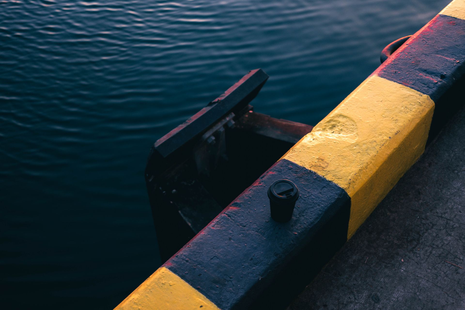 A colorful dock edge overlooking calm waters in Sochi, Russia, during a serene day.
