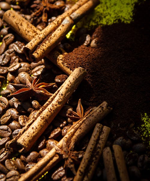Photograph of Cinnamon Sticks on Top of Coffee Beans