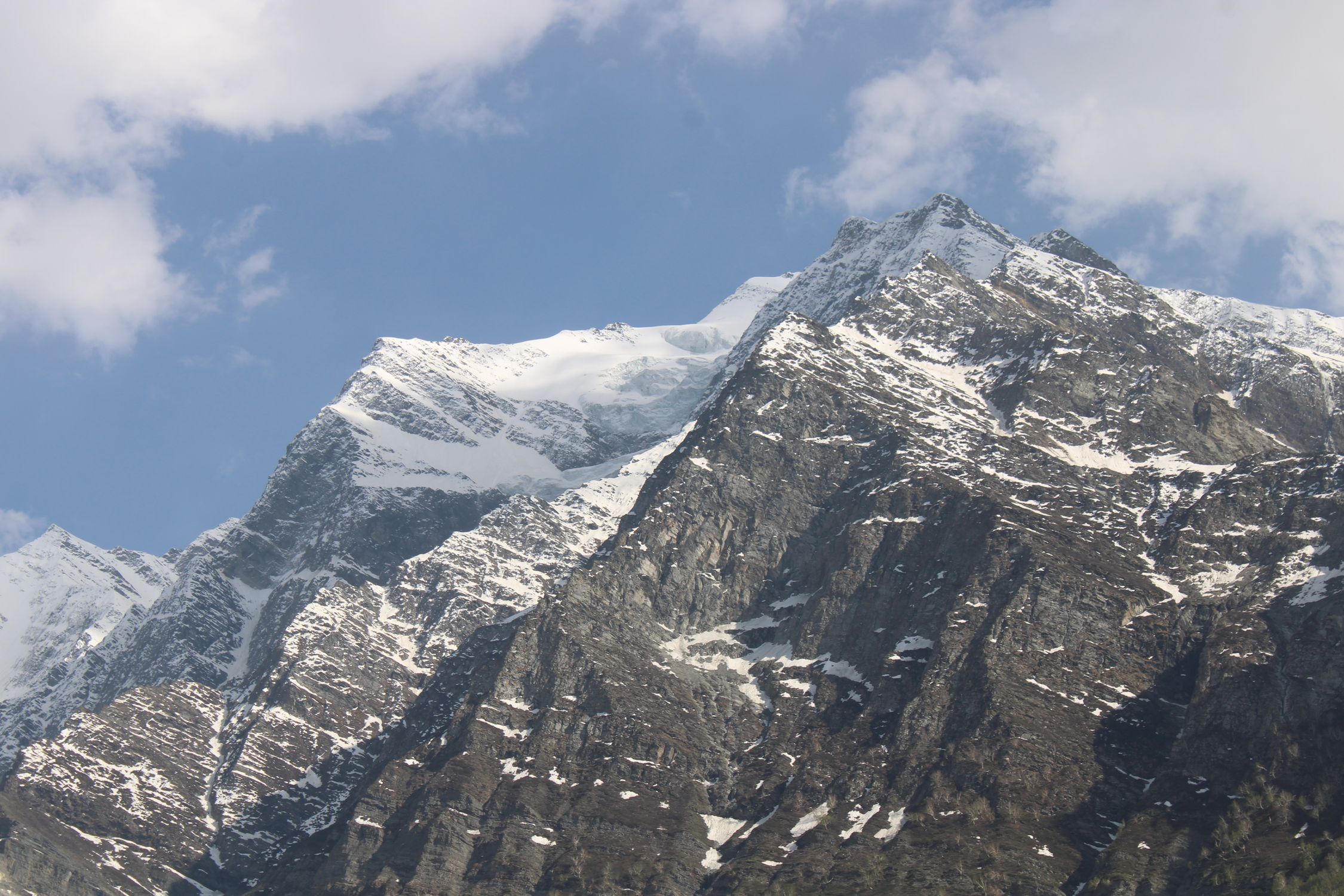 An Aerial Photography of a Snow Covered Mountain Under the Blue Sky and ...