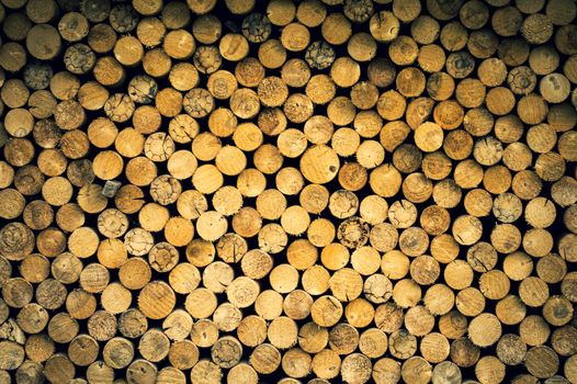 A neatly stacked pile of seasoned firewood displaying rich natural textures.