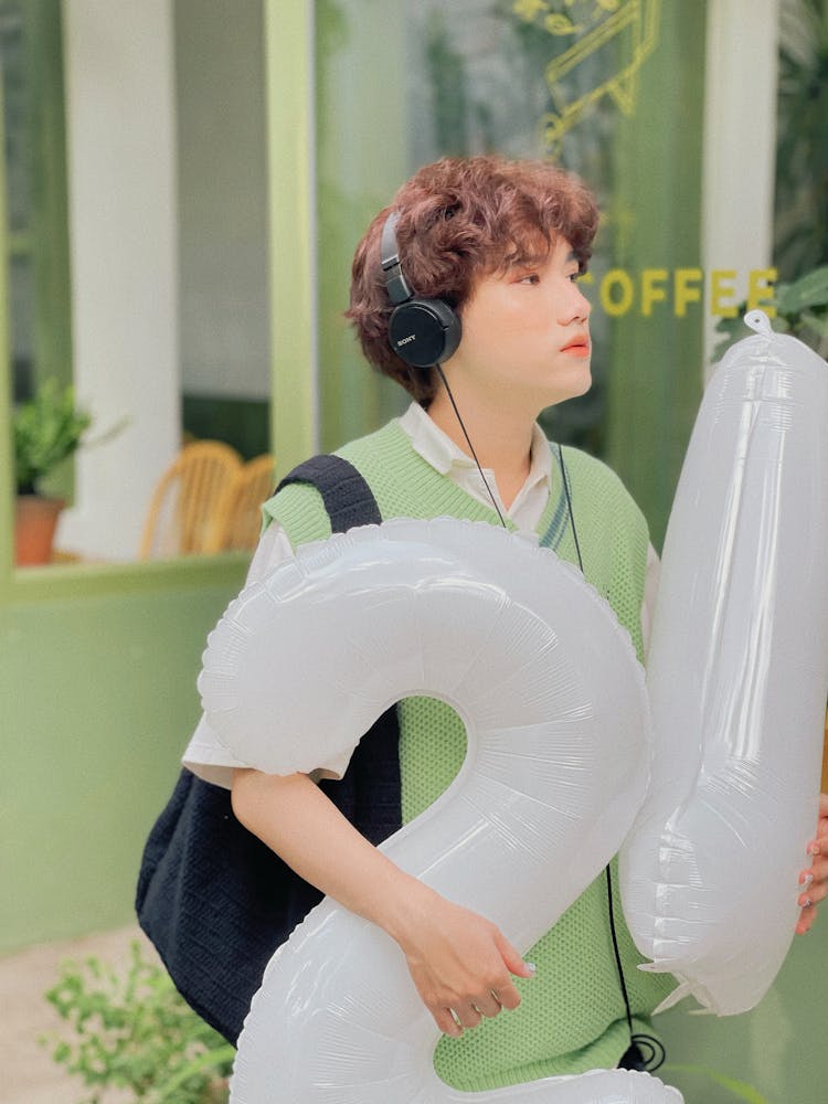 Man Holding Number Balloons