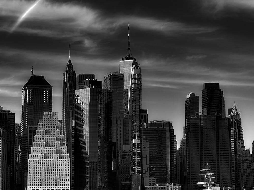 Monochrome Photo of High-rise Buildings under Cloudy Sky 